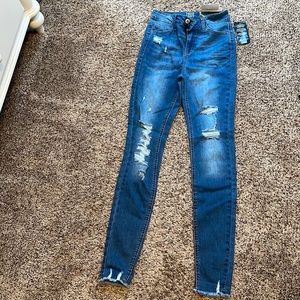 Woman’s distressed ripped skinny high rise jeans